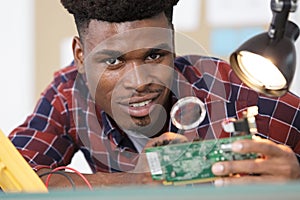 Electronics repair master using magnifying glass