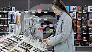 Electronics store, girl looks at smart watch, modern technology