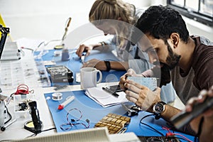 Electronics technicians team working on computer parts