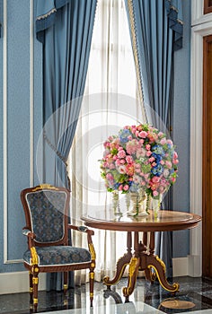 Elegance armchair and flower bouquet on table