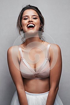 Elegance is the only beauty that never fades. Portrait of a beautiful young woman posing in studio while wearing a bra