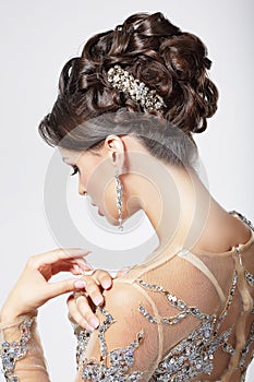 Elegance and Chic. Beautiful Brunette with Classy Hairstyle. Luxury