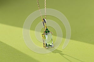 Elegance gold pendant necklace with baguette cut green gemstone