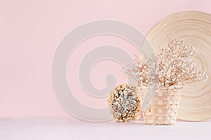 Elegance home eco decor - white dried flowers bouquet in basket with decorative plate, bunch sticks on fashion pink background.