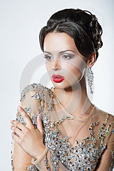 Elegance. Luxurious Good Looking Woman in Dress with Sequins and Jewels