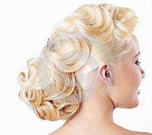 Elegance. Rear View of Blonde with Festive Hairstyle