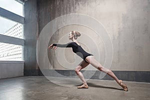 Elegance slim woman dancing near the window.