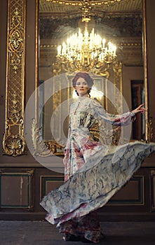 Elegance woman with flying dress in palace room