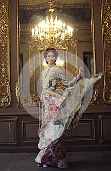 Elegance woman with flying dress in palace room