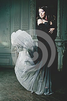 Elegance woman with flying dress in palace room