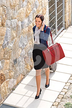 Elegance woman leaving home luggage calling phone