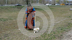 Elegant adult woman walks with her pet.