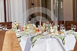 Elegant aesthetic wedding table setting, flowers arrangement under sunlight shadows