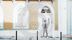 An elegant African man near a facade