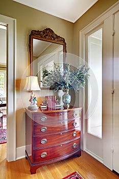 Elegant antique furniture near front door photo