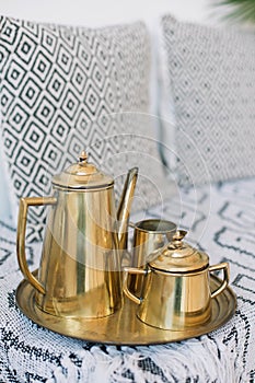 Elegant antique golden coffee set with coffee pot and sugar bowl and tray. antique golden coffee set. morning tea. boho style