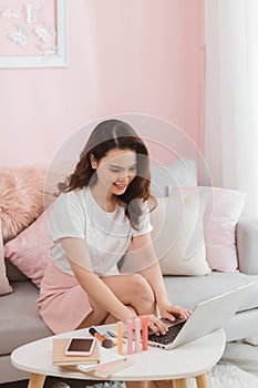 Elegant asian lady freelance worker typing on laptop computer replying message online shop customer service internet