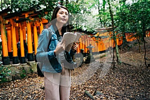 Elegant asian photographer holding her guidebook photo