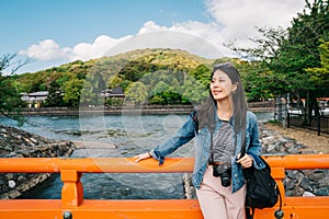 An elegant asian traveler relying on the handrail