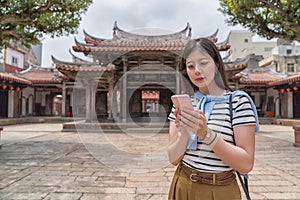 Elegant asian woman searching by the phone