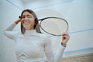 Elegant and athletic lady playing squash skillfully handling racket