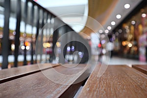 Elegant atmosphere in a shopping mall in the center of the city with wooden tables.