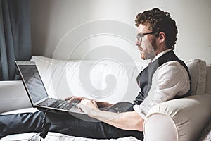 Elegant attractive fashion hipster man using notebook