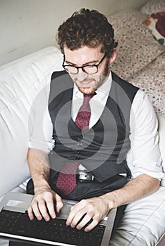 Elegant attractive fashion hipster man using notebook