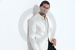 elegant attractive man with glasses wearing white jacket suit