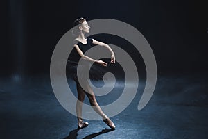 elegant ballerina dancing in pointe shoes and black tutu
