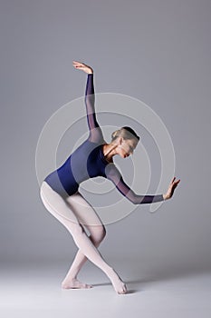 Elegant ballerina. A young graceful ballet dancer, dressed in a leotard and pointes shoes demonstrates her dance skills. Power and