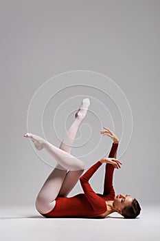 Elegant ballerina. A young graceful ballet dancer, dressed in a leotard and pointes shoes demonstrates her dance skills. Power and