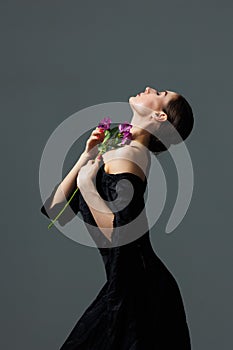 Elegant ballerina. A young graceful ballet dancer, dressed in pointes shoes demonstrates her dance skills. Power and refinement of