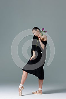 Elegant ballerina. A young graceful ballet dancer, dressed in pointes shoes demonstrates her dance skills. Power and refinement of