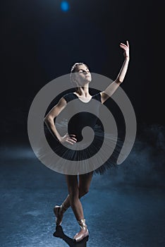 elegant ballet dancer in pointe shoes and black tutu