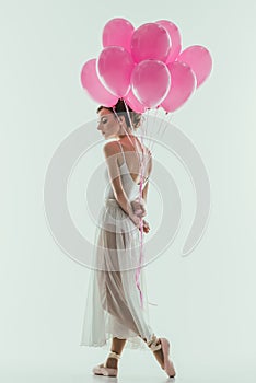 elegant ballet dancer in white dress with pink balloons
