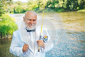 Elegant bearded man fishing. Fishing as holiday. Fisherman relax while fishing on the lake at the morning. I am retired