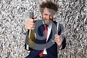 Elegant bearded man with moustache showing and recommending champagne bottle photo
