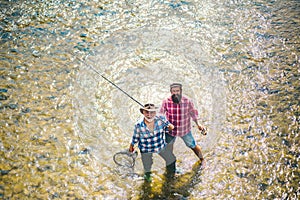 Elegant bearded men fishing. Relax in natural environment. Off limits fishing. Happy fishermen friendship. Fishman