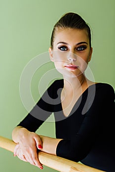 Elegant beautiful ballerina with a perfect body doing stretching exercise.