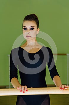 Elegant beautiful ballerina with a perfect body doing stretching exercise.