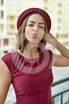 Elegant beautiful young woman standing on balcony, portrait