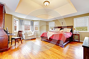 Elegant bedroom with cherrywood furniture set and high ceiling.