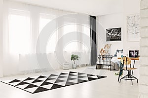 Elegant bedroom interior with copy space and black and white patterned rug on the floor