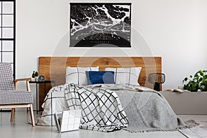 Elegant bedroom with white wall and chequered bedding