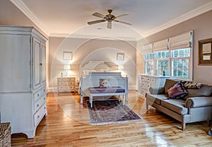 Elegant bedroom with wood floors and tasteful furniture photo