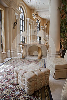 Elegant beige pouffe on carpet