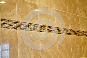 Elegant Beige Tiled Wall with Mosaic Accent Close-Up photo
