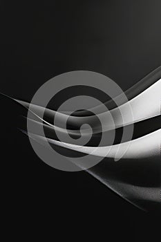 Elegant black fabric folds with light reflections, minimal backdrop