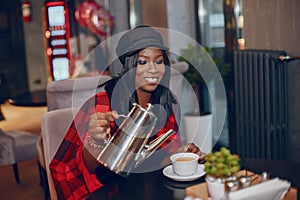 Elegant black girl in a cafe